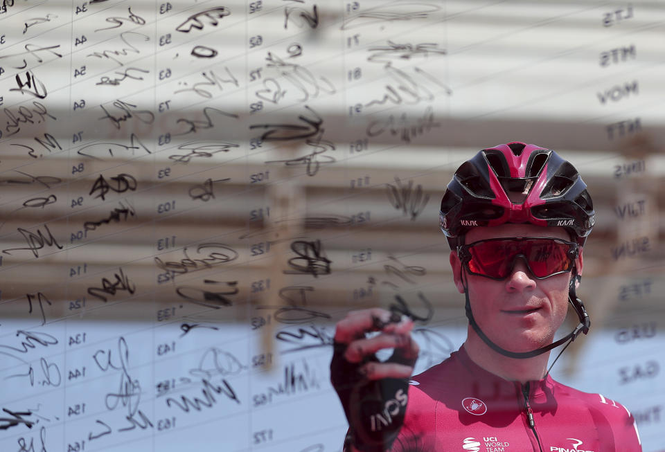 Britain's Chris Froome of Ineos Team signs in before start of the first stage of the UAE cycling tour in Dubai, United Arab Emirates, Sunday, Feb, 23, 2020. (AP Photo/ Mahmoud Khaled)