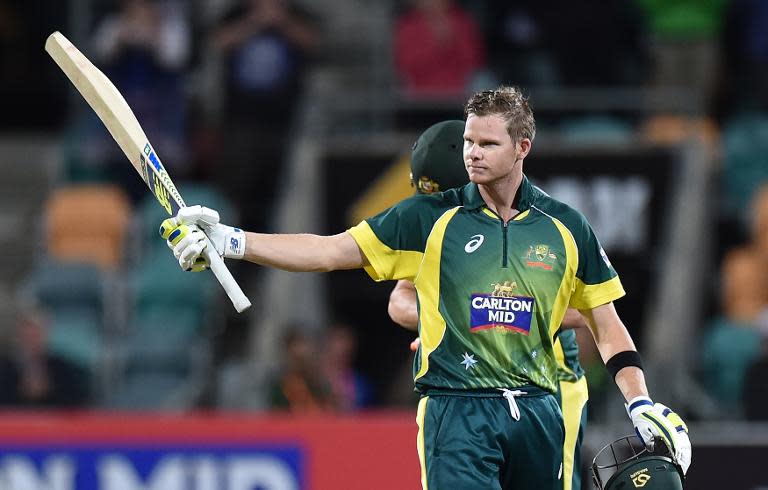 Australia's Steve Smith raises his bat after scoring a century during the one-day international against England at Bellerive Oval in Hobart on January 23, 2015