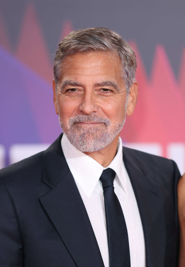 A bearded George at an event in a suit and tie