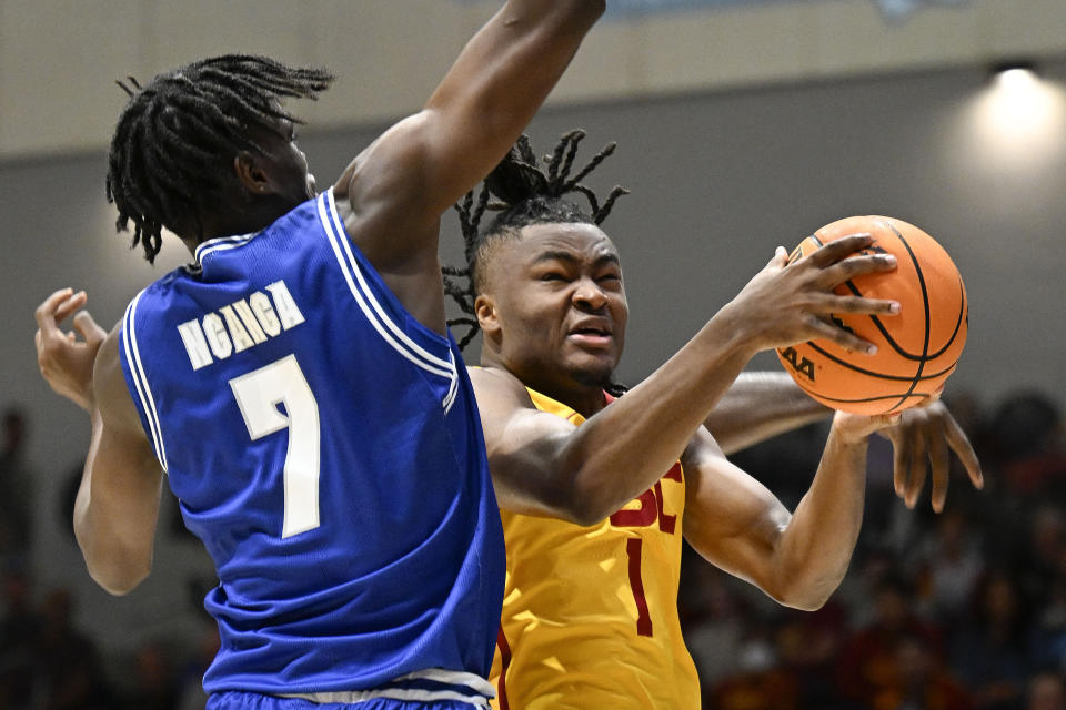 Southern California guard Isaiah Collier (1) shoots past Seton Hall Sadraque NgaNga (7) during the first half of an NCAA college basketball game Thursday, Nov. 23, 2023, in San Diego. (AP Photo/Denis Poroy)