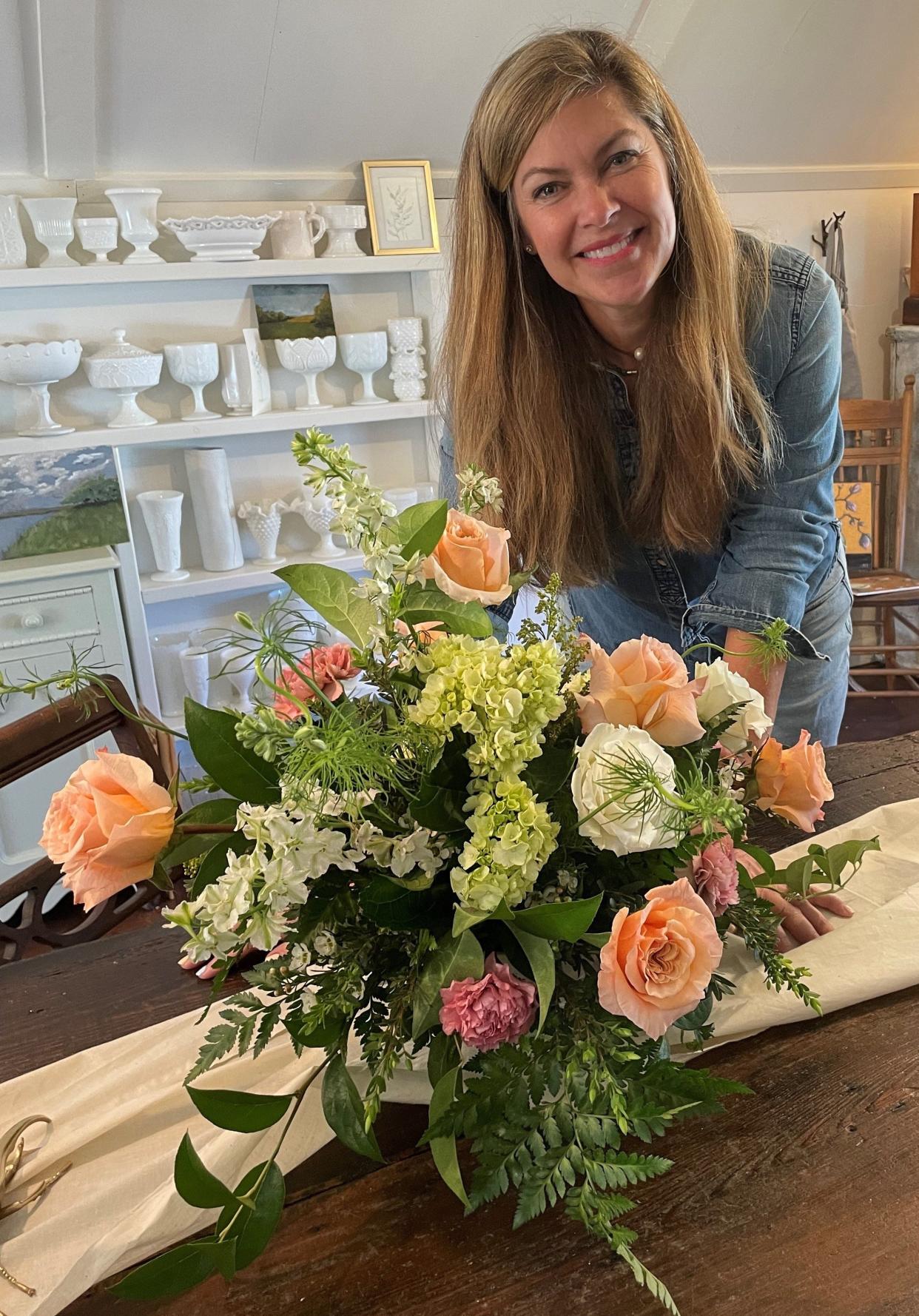 Julie Miltimore of Newark works on a floral arrangement for Foraged 774 in the loft at her home.