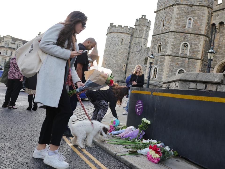 Mourners lay flowers at Windsor Castle following Queen Elizabeth II's death.