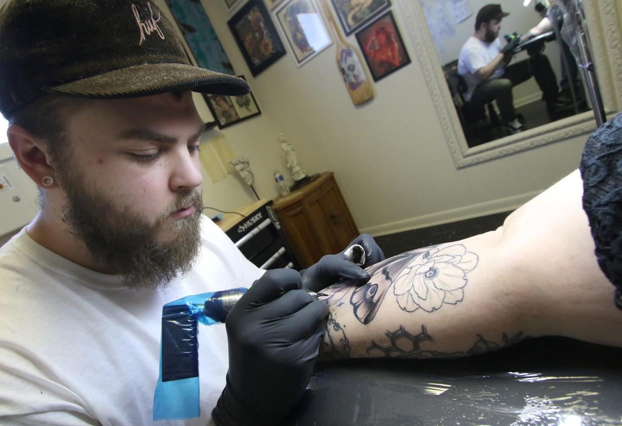 Tevin Greene works on the arm of Haley Matthews Thursday afternoon, April 18, 2024, at Greeneworks Tattoo in Shelby.