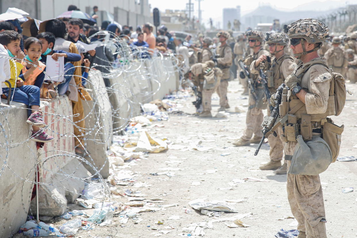 U.S. Marines with Special Purpose Marine Air-Ground Task Force - Crisis Response - Central Command, provide assistance during an evacuation at Hamid Karzai International Airport, in Kabul, Afghanistan, August 20, 2021. Lance Cpl. Nicholas Guevara/U.S. Marine Corps/Handout via REUTERS    THIS IMAGE HAS BEEN SUPPLIED BY A THIRD PARTY