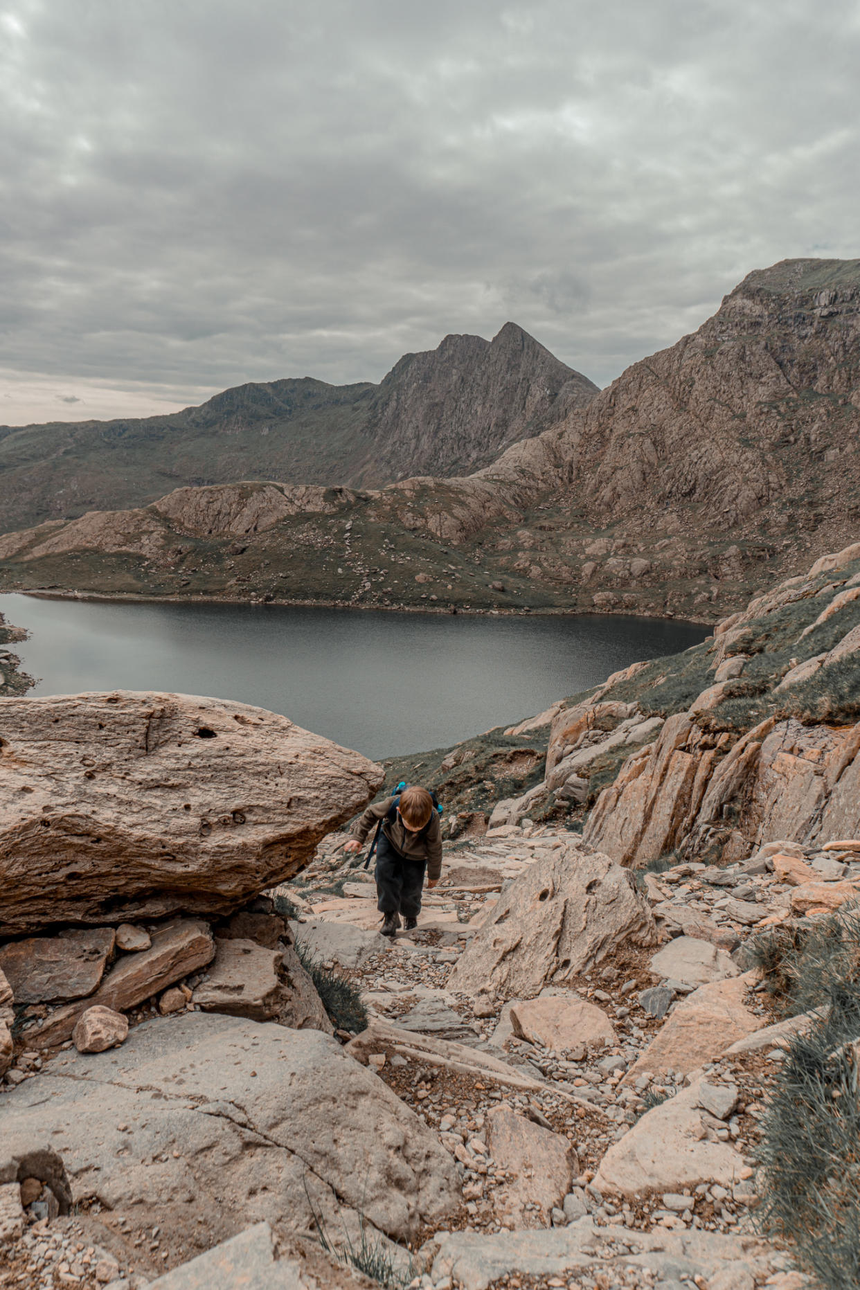 A boy walking on a mountain