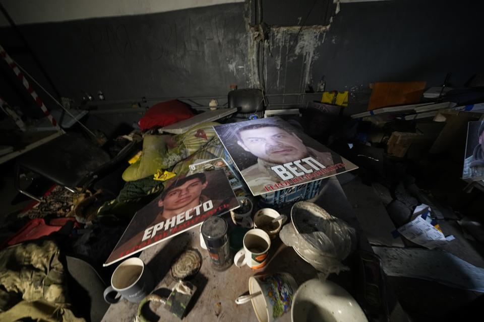 Posters of Ukrainian heroes lay on a table in a labyrinth of the Metallurgical Combine Azovstal where Ukrainian troops were based in Mariupol, in a territory which is under the control of the Government of the Donetsk People's Republic, eastern Ukraine, Monday, June 13, 2022. This photo was taken during a trip organized by the Russian Ministry of Defense. (AP Photo)