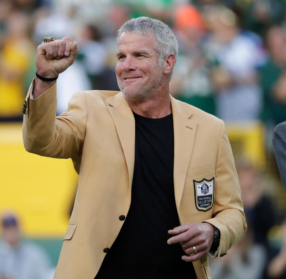 Brett Favre shows off his Pro Football Hall of Fame ring after receiving it during a 2016 game at Lambeau Field.