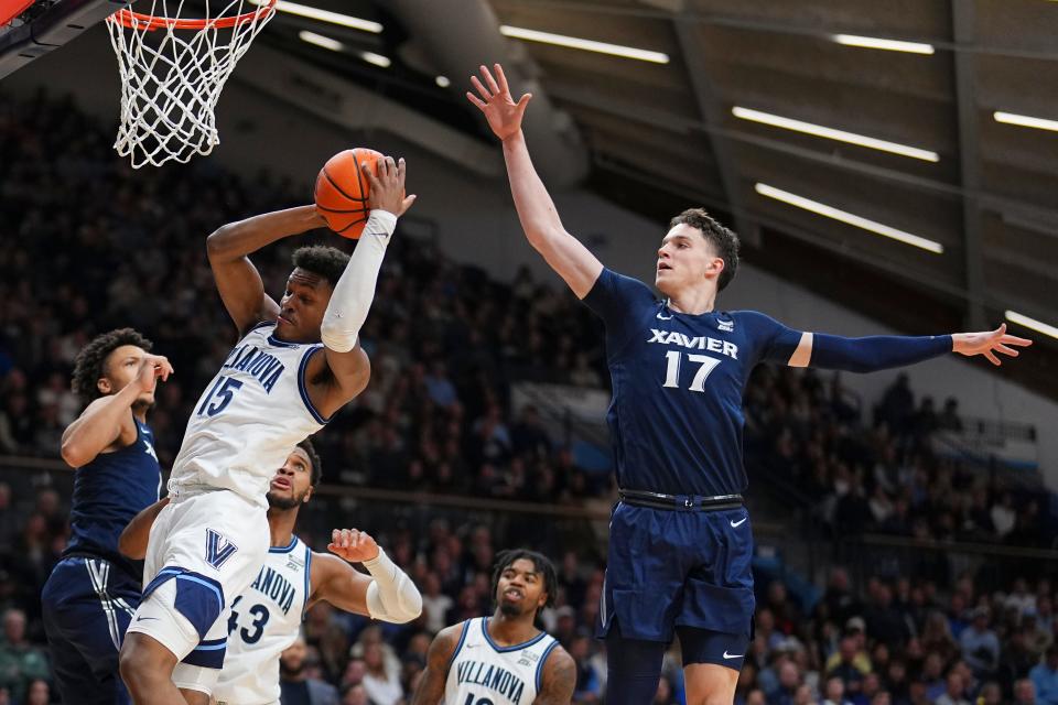 VILLANOVA, PENNSYLVANIA - JANUARY 3: Jordan Longino #15 of the Villanova Wildcats grabs a rebound against Lazar Djokovic #17 of the Xavier Musketeers in the first half at Finneran Pavilion on January 3, 2024 in Villanova, Pennsylvania.