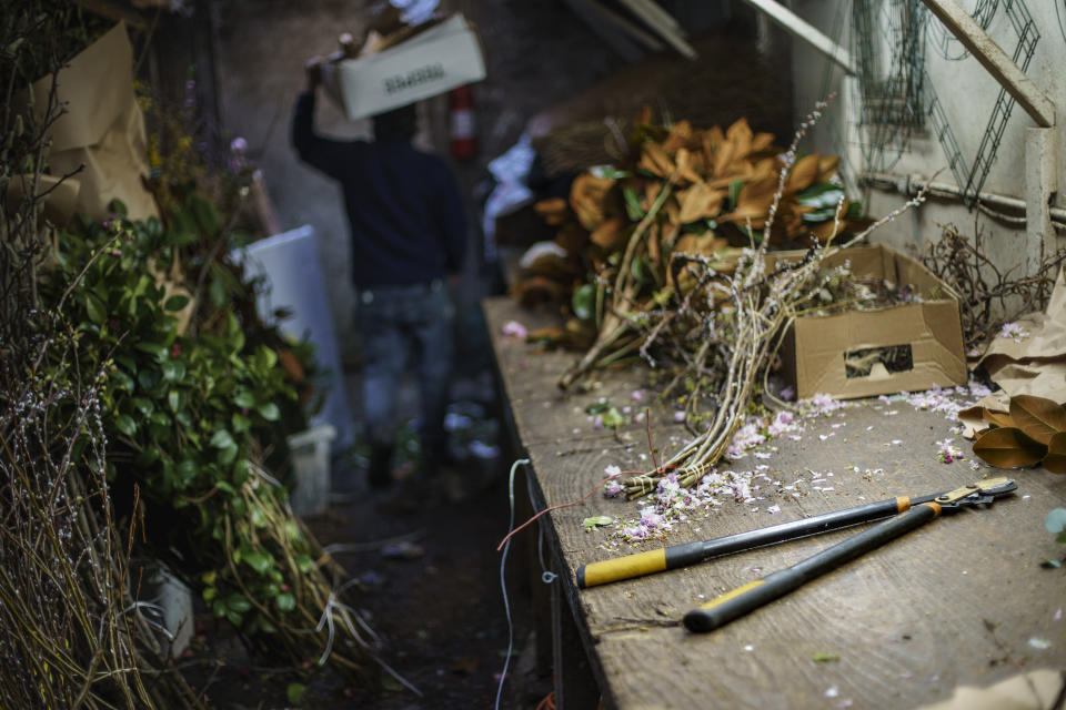 A lopper lays on the table where Eddy Marquez used to trim plants at US Evergreen Wholesale Florist for 33 years in New York, Wednesday, March 16, 2022. Marquez, died from COVID on April 8, 2020 during one of the deadliest weeks in New York City. The father of three loved plants and the yard of their home is filled with the bushes and trees he tended. He died days after his brother-in-law who lived in the same house. His daughter, Ivett Marquez, recalled her dad working long hours, but reserving Sundays for family time. "He was an amazing father. He was an amazing husband, an amazing person. My father was just our best friend. You know, I guess his daughter's first love," says Marquez. "That was what he was. He was everything to us. A supporter, a friend, just everything. He loved his job. He loved this family. He loved his house, his plants. That was just Eddy." She now tends the plants in his place. (AP Photo/David Goldman)