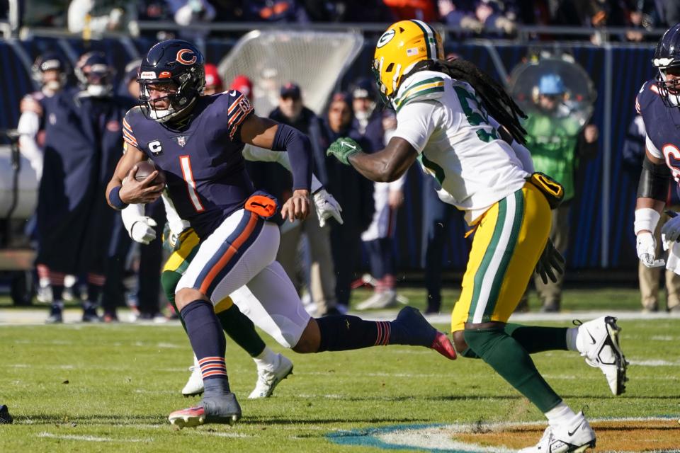 Chicago Bears' Justin Fields runs for a touchdown during the first half of an NFL football game against the Green Bay Packers Sunday, Dec. 4, 2022, in Chicago. (AP Photo/Charles Rex Arbogast)