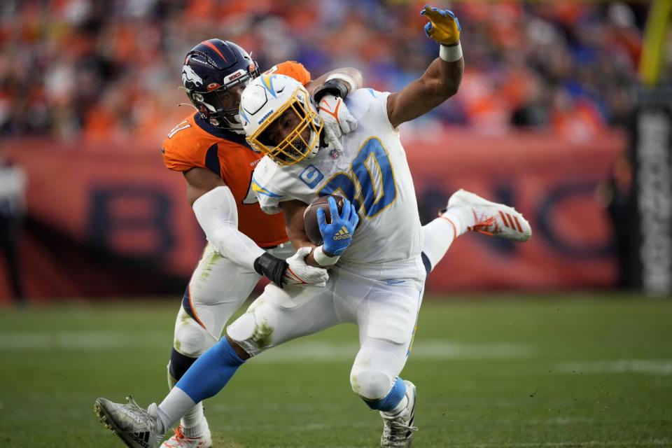 Broncos linebacker Kenny Young (41) tackles Chargers running back Austin Ekeler.