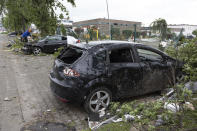 Destroyed cars lie by a road following a tornado that hit thea area on Friday, in Paderborn and Lippstadt, Germany, Saturday, May 21, 2022. (Friso Gentsch/dpa via AP)