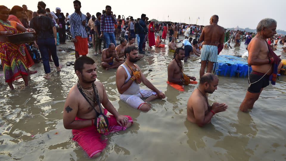 Hindus in Prayagraj pray to the sun god while taking a dip at the Triveni Sangam, the confluence of the Ganges, Yamuna and mythical Saraswati River, during the October 2022 partial solar eclipse. - Sanjay Kanojia/AFP/Getty Images