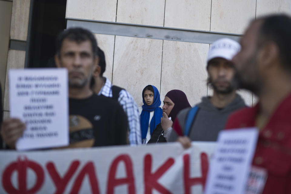 Syrians who live in Malakasa refugee camp, on the outskirt of Athens protest against the living conditions at the camp, outside the Ministry of Migration in Nikea, suburb of Athens, Monday, Oct. 8, 2018. (AP Photo/Petros Giannakouris)