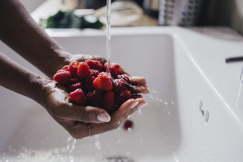 woman washing raspberries