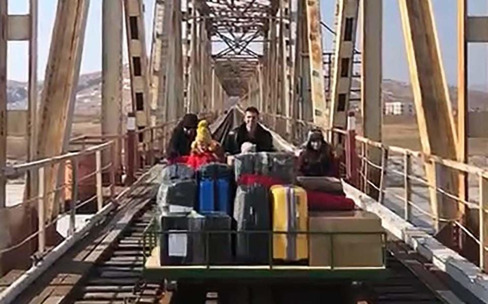 The family cross a bridge - TASS