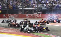 Mercedes Formula One driver Nico Rosberg of Germany (front, C) leads Red Bull Formula One driver Sebastian Vettel of Germany on turn one of lap one during the Singapore F1 Grand Prix at the Marina Bay street circuit in Singapore September 22, 2013. REUTERS/Tim Chong (SINGAPORE - Tags: SPORT MOTORSPORT F1)