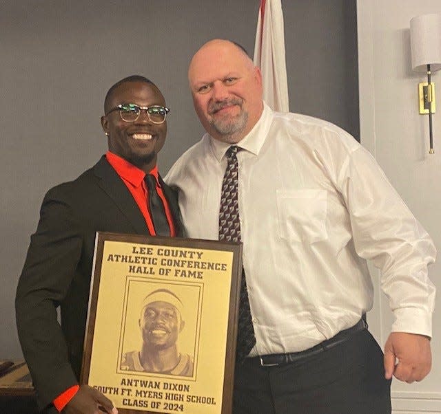 Antwan Dixon, who starred in football, basketball and track and field at South Fort Myers High School, was among eight members of the Lee County Athletic Conference Hall of Fame's Class of 2024. With him is former Wolfpack head football coach Grant Redhead.