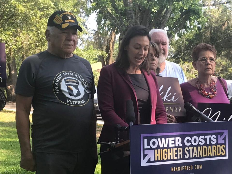 Wilson Barnes stands next to Nikki Fried as she faces the media after a roundtable discussion of issues facing senior citizens