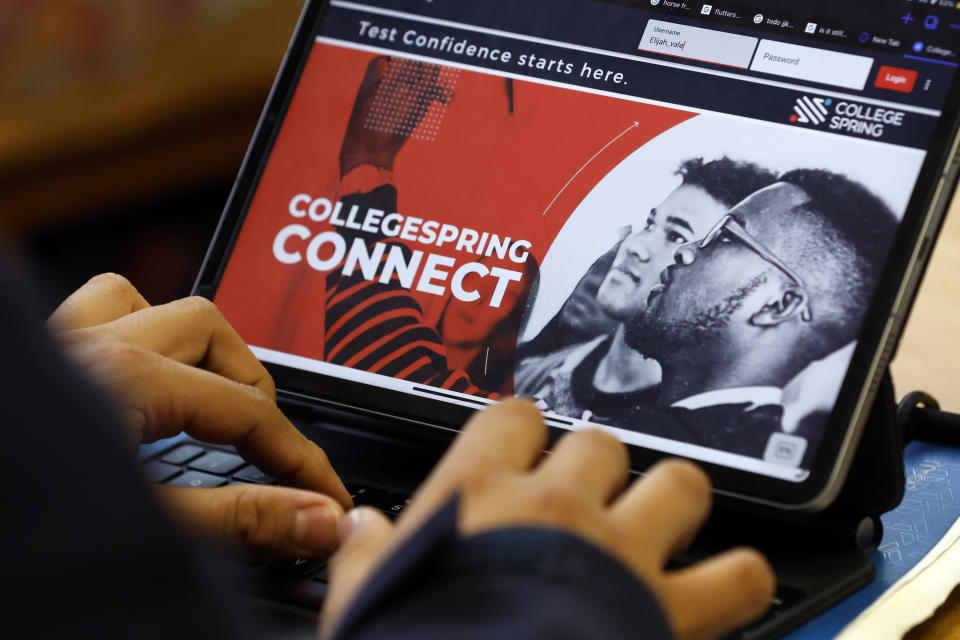 Students use a digital platform to prepare them for the digital SAT, Wednesday, March 6, 2024, at Holy Family Cristo Rey Catholic High School in Birmingham, Ala. (AP Photo/Butch Dill)