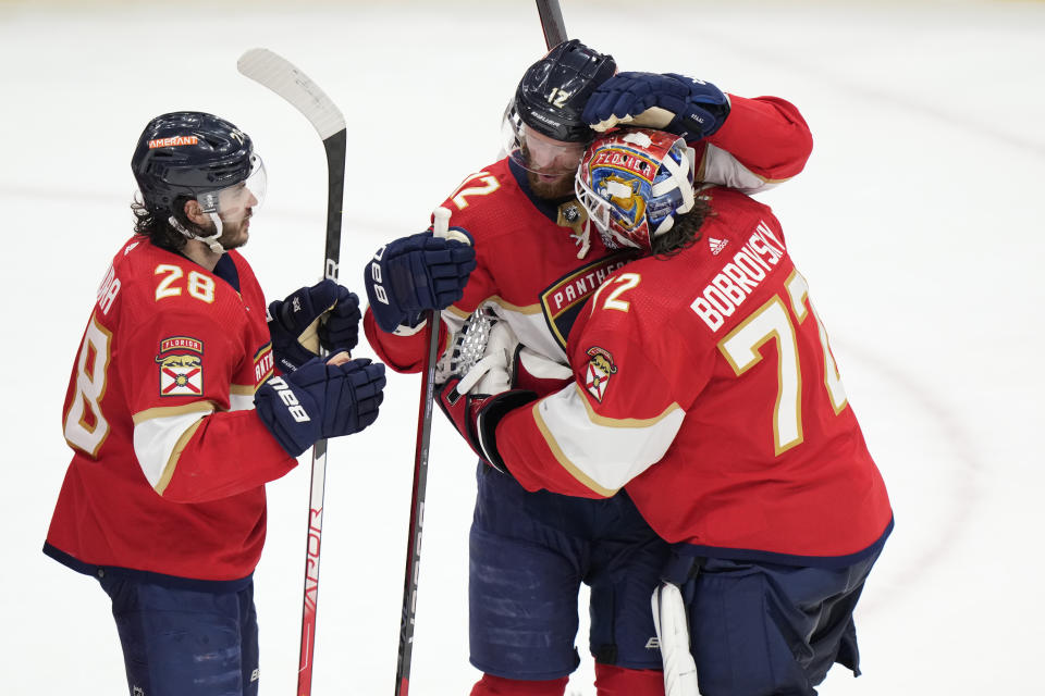 Florida Panthers goaltender Sergei Bobrovsky (72) is congratulated by defenseman Josh Mahura (28) and center Eric Staal (12) after the Panthers beat the Carolina Hurricanes 1-0 in Game 3 of the NHL hockey Stanley Cup Eastern Conference finals, Monday, May 22, 2023, in Sunrise, Fla. (AP Photo/Wilfredo Lee)