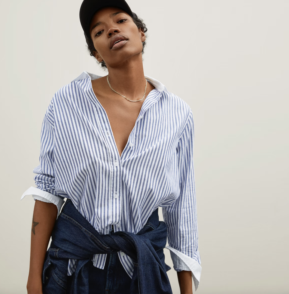 woman wearing blue and white striped The Silky Cotton Relaxed Shirt in Mariner Blue/White (Photo via Everlane)