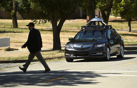 FILE PHOTO: An autonomous version of Acura's RLX Sport Hybrid SH-AWD stops for a simulated pedestrian crossing at carmaker Honda's testing grounds at the GoMentum Station autonomous vehicle test facility in Concord, California, U.S., June 1, 2016. REUTERS/Noah Berger/File Photo