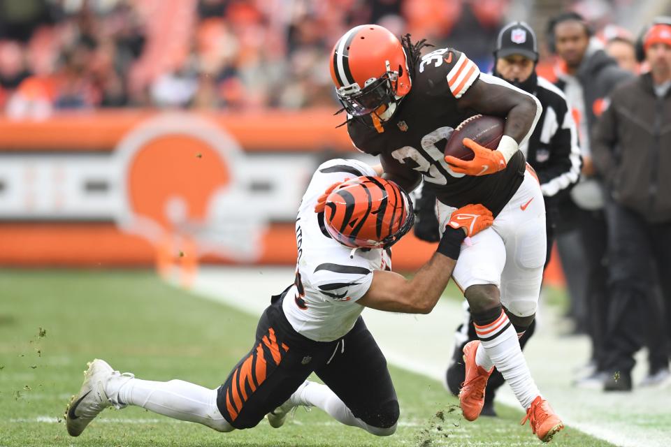 Cleveland Browns running back D'Ernest Johnson (30) is forced out of bounds by Cincinnati Bengals outside linebacker Austin Calitro (48) during the first half of an NFL football game, Sunday, Jan. 9, 2022, in Cleveland. (AP Photo/Nick Cammett)