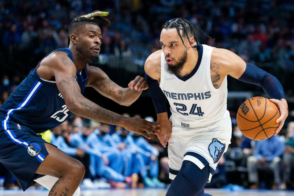 Memphis Grizzlies forward Dillon Brooks (24) controls the ball as Dallas Mavericks forward Reggie Bullock (25) defends during the first half of an NBA basketball game, Saturday, Dec. 4, 2021, in Dallas. (AP Photo/Sam Hodde)