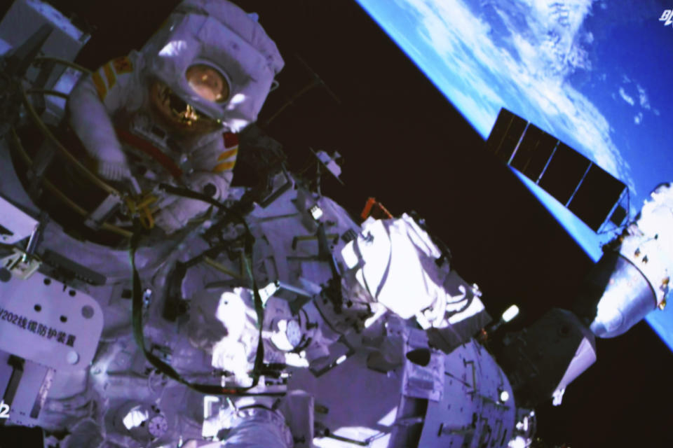 In this photo released by China's Xinhua News Agency, a screen at the Beijing Aerospace Control Center in Beijing shows Chinese astronaut Cai Xuzhe exiting the station lab module Wentian to conduct extravehicular activities, also known as a spacewalk, Saturday, Sept. 17, 2022. (Guo Zhongzheng/Xinhua via AP)