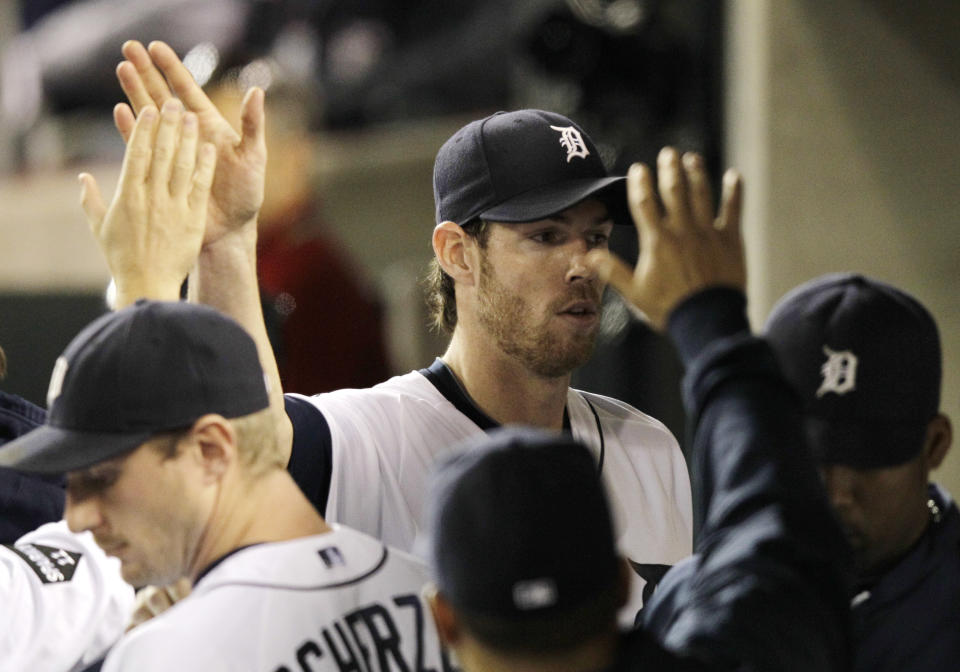 Detroit Tigers starting pitcher Doug Fister is greeted in the dugout after being replaced by relief pitcher Joaquin Benoit in the eighth inning of Game 3 of baseball's American League championship series against the Texas Rangers, Tuesday, Oct. 11, 2011, in Detroit. (AP Photo/Paul Sancya)