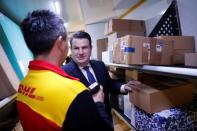 German Labour Minister Hubertus Heil talks to a truck driver of German postal and logistics group Deutsche Post DHL during his visit to a parcels distribution centre in Berlin