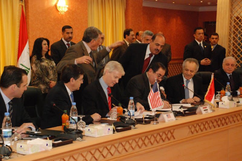 Iraqi Foreign Minister Hoshiyar Zebari (4th,L) and U.S. ambassador to Iraq Ryan Crocker (3rd,L) sign the Iraq-United States security pact on November 17, 2008, one day after the Iraqi Cabinet approved it. File Photo courtesy Iraqi Ministry of Foreign Affairs