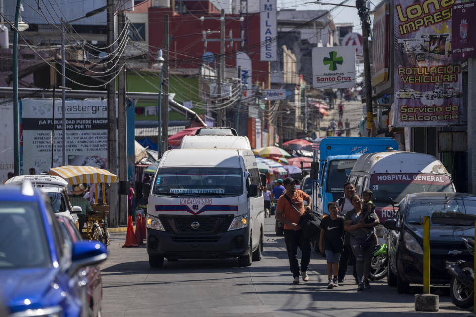 A passenger van starts its route from a station in Tapachula, Mexico, Thursday, Jan. 19, 2023. With threatening phone calls, burned minibuses and at least three suspected killings, street gangs more closely associated with Central America are imposing their brand of terror-based extortion on transport drivers in southern Mexico. (AP Photo/Moises Castillo)