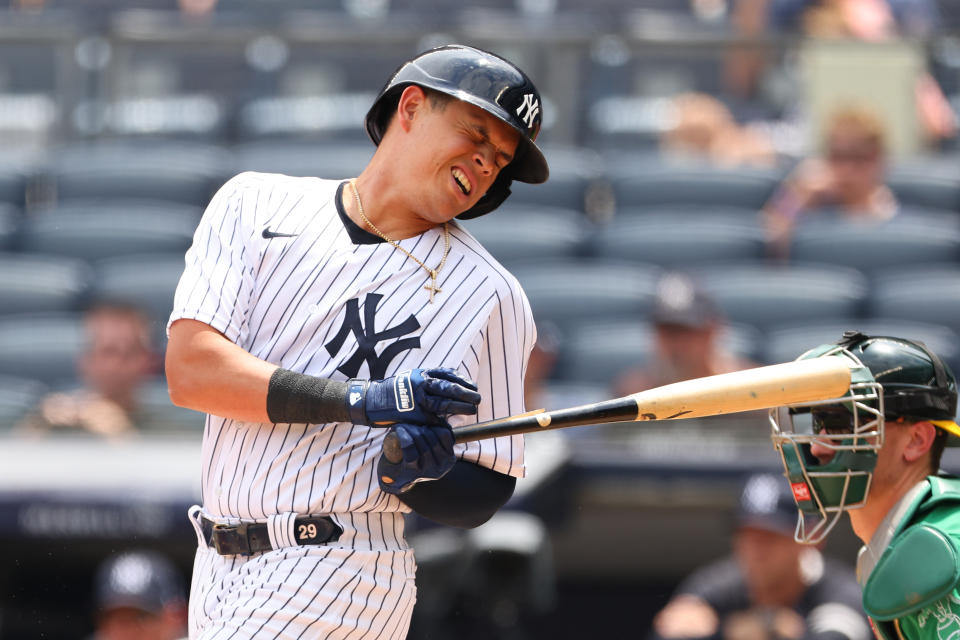 Gio Urshela of the New York Yankees is hit with a splinter part of the bat as he hits into a double play.