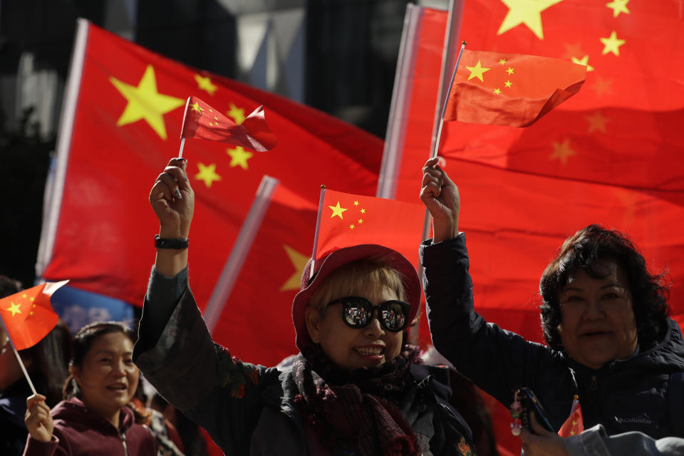 Pro-Beijing supporters wave the Chinese national flags during a rally in Hong Kong on Saturday, Dec. 7, 2019. Six months of unrest have tipped Hong Kong's already weak economy into recession. (AP Photo/Mark Schiefelbein)