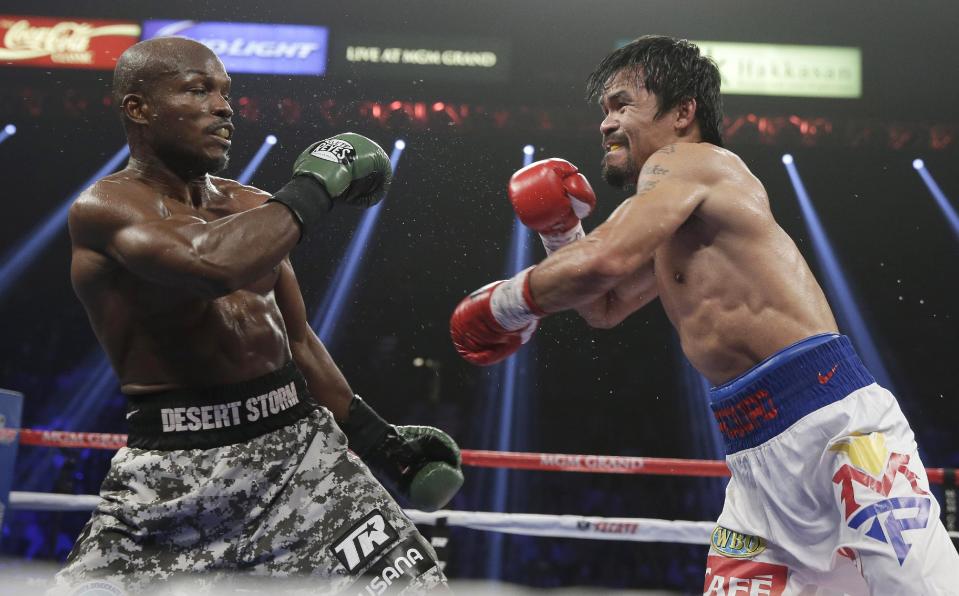 Timothy Bradley, leans back as Manny Pacquiao, of the Philippines, throws a punch during their WBO welterweight title boxing fight Saturday, April 12, 2014, in Las Vegas. (AP Photo/Isaac Brekken)