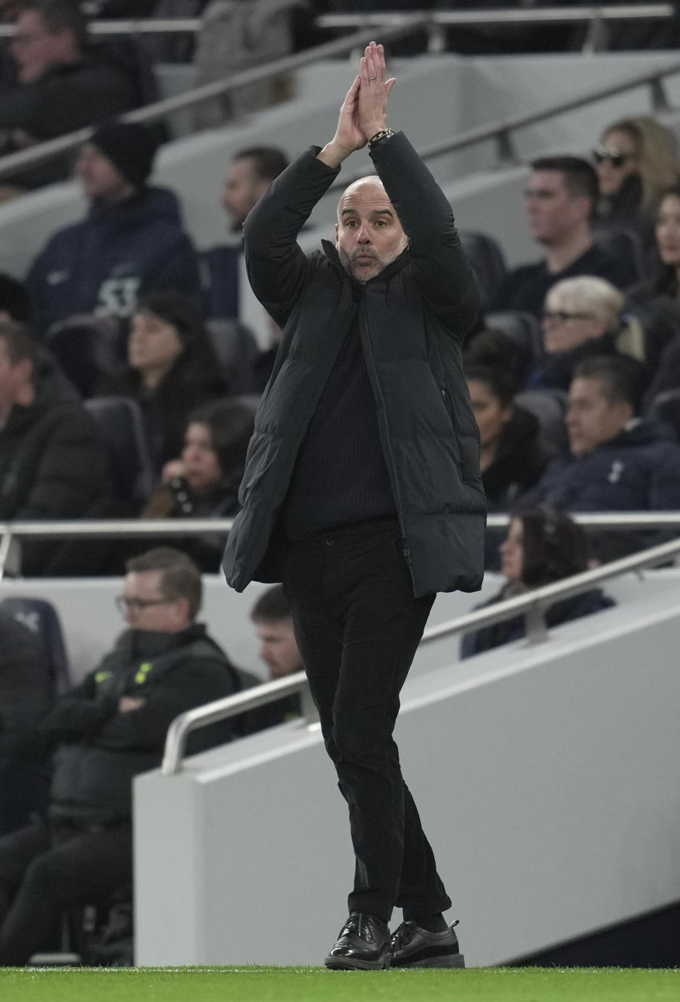 Manchester City's head coach Pep Guardiola reacts during an English Premier League soccer match between Tottenham Hotspur and Manchester City at the Tottenham Hotspur Stadium in London, Sunday, Feb. 5, 2023. (AP Photo/Kin Cheung)