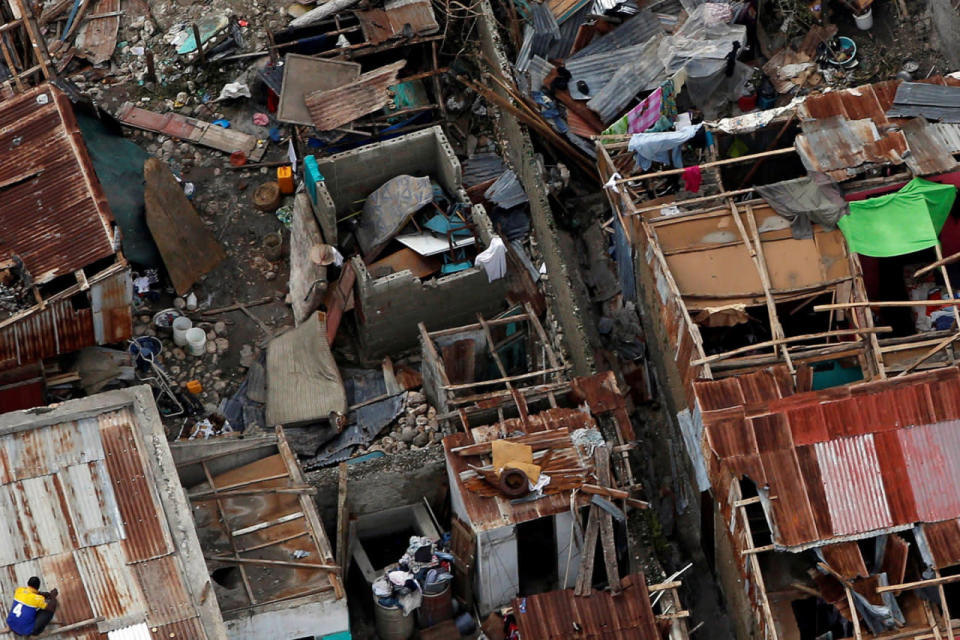 <p>People try to rebuild their destroyed houses after Hurricane Matthew passes Jeremie, Haiti, October 6, 2016. (REUTERS/Carlos Garcia Rawlins)</p>