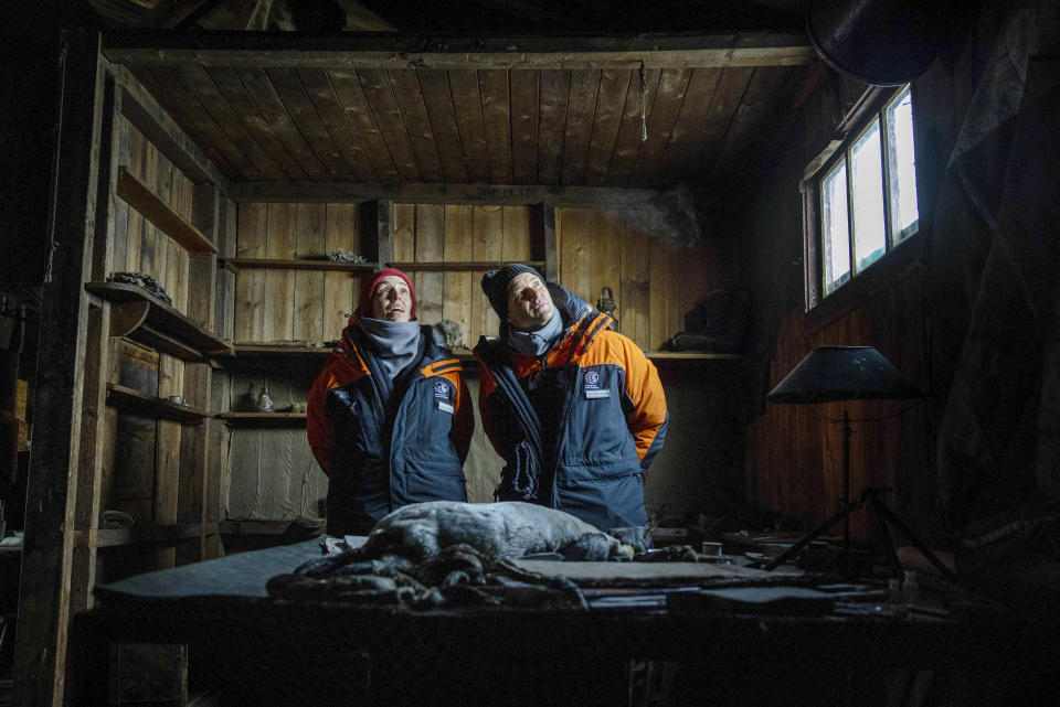 New Zealand Prime Minister Jacinda Ardern and her partner Clarke Gayford look around Scott's Terra Nova hut at Cape Evans in Antarctica, Thursday, Oct. 27, 2022. Ardern this week is making a rare visit by a world leader to Antarctica. She's seeing firsthand the research on global warming that's taking place and marking the 65th anniversary of New Zealand's Scott Base, which will soon be demolished to make way for a new base. (Mike Scott/NZ Herald/Pool Photo via AP)