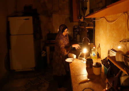 A Palestinian woman washes up in her kitchen during power cut at Shati refugee camp in Gaza City April 25, 2017. REUTERS/Mohammed Salem