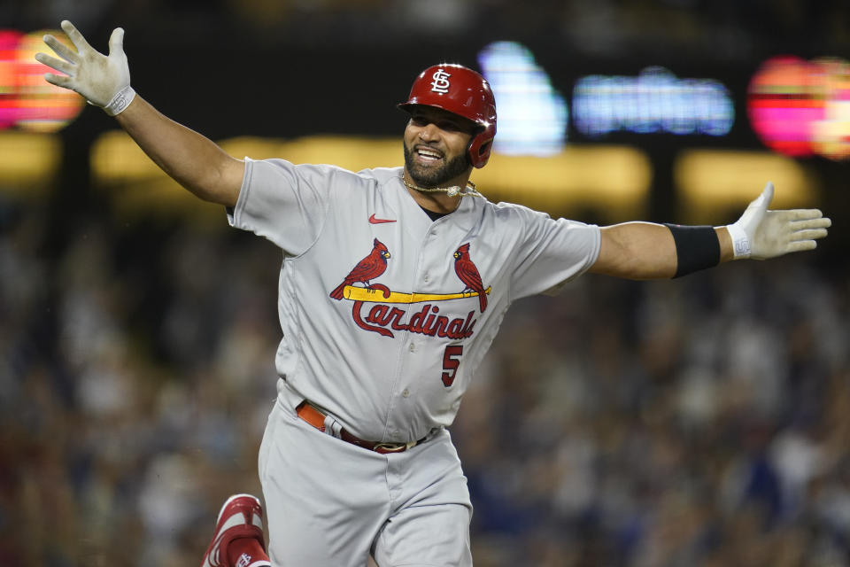 St. Louis Cardinals designated hitter Albert Pujols (5) reacts after hitting a home run during the fourth inning of a baseball game against the Los Angeles Dodgers in Los Angeles, Friday, Sept. 23, 2022. Brendan Donovan and Tommy Edman also scored. It was Pujols' 700th career home run. (AP Photo/Ashley Landis)