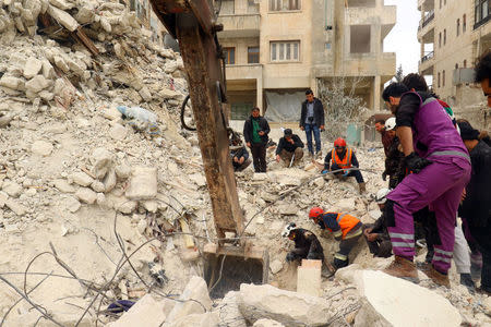 Civil Defence members and civilians remove rubble in a damaged site after an airstrike on Idlib city, Syria March 15, 2017. REUTERS/Ammar Abdullah