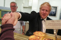 Britain's Prime Minister Boris Johnson visits a bakery during a General Election campaign trail stop in Wells, England, Thursday, Nov. 14, 2019. Britain goes to the polls on Dec. 12. (AP Photo/Frank Augstein, Pool)