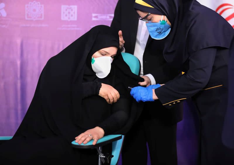 A nurse prepares to inject a volunteer taking part in an Iranian coronavirus disease (COVID-19) vaccine trial in Tehran