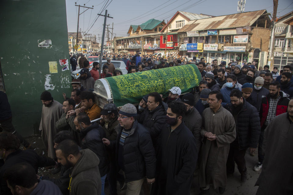 Kashmiri Muslims carry the coffin of Basharat Ahmad Zargar in Srinagar, Indian-controlled Kashmir, Sunday, Feb.14, 2021. Zargar, who was working at a power project, was among the dozens killed after a part of a Himalayan glacier broke off on February 7 sending a devastating flood downriver slamming into two hydropower projects in northern India. (AP Photo/Mukhtar Khan)