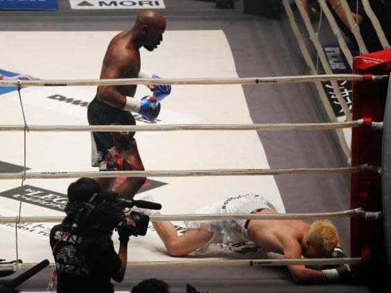 Mayweather stands over Nasukawa after knocking him down (Reuters)