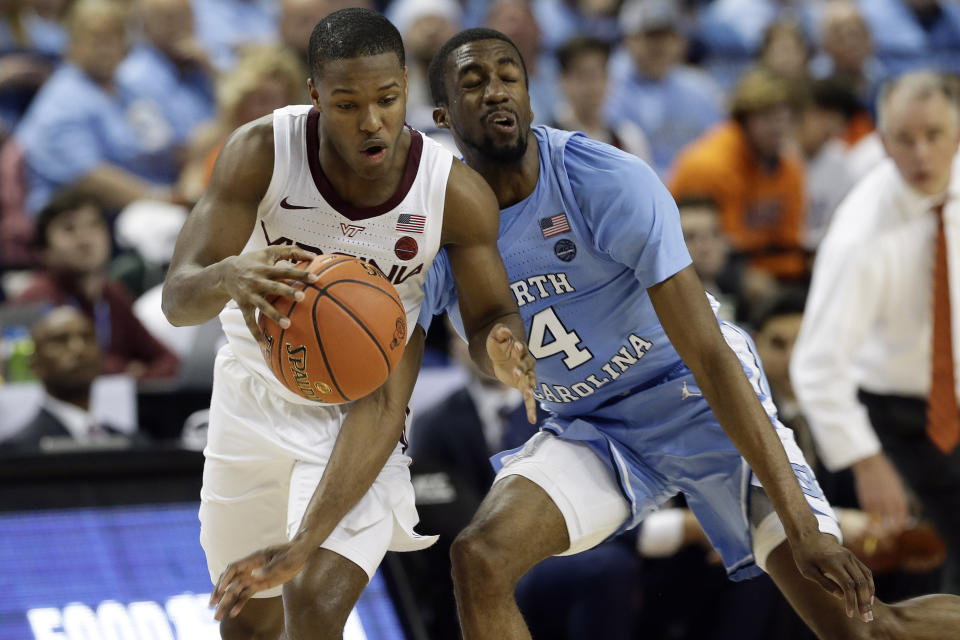 Virginia Tech guard Jalen Cone (15) dribbles while North Carolina guard Brandon Robinson (4) defends during the second half of an NCAA college basketball game at the Atlantic Coast Conference tournament in Greensboro, N.C., Tuesday, March 10, 2020. (AP Photo/Gerry Broome)