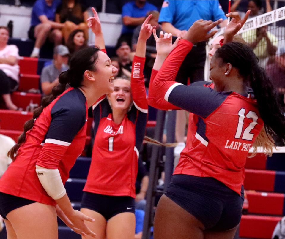 Oakland's Elisa Fries (11), Oakland's Callie Wilson (1) and Oakland's Alyssaa Amuzu (12) celebrate a point against Siegel during the volleyball game at Oakland on Tuesday, Aug. 22, 2023.