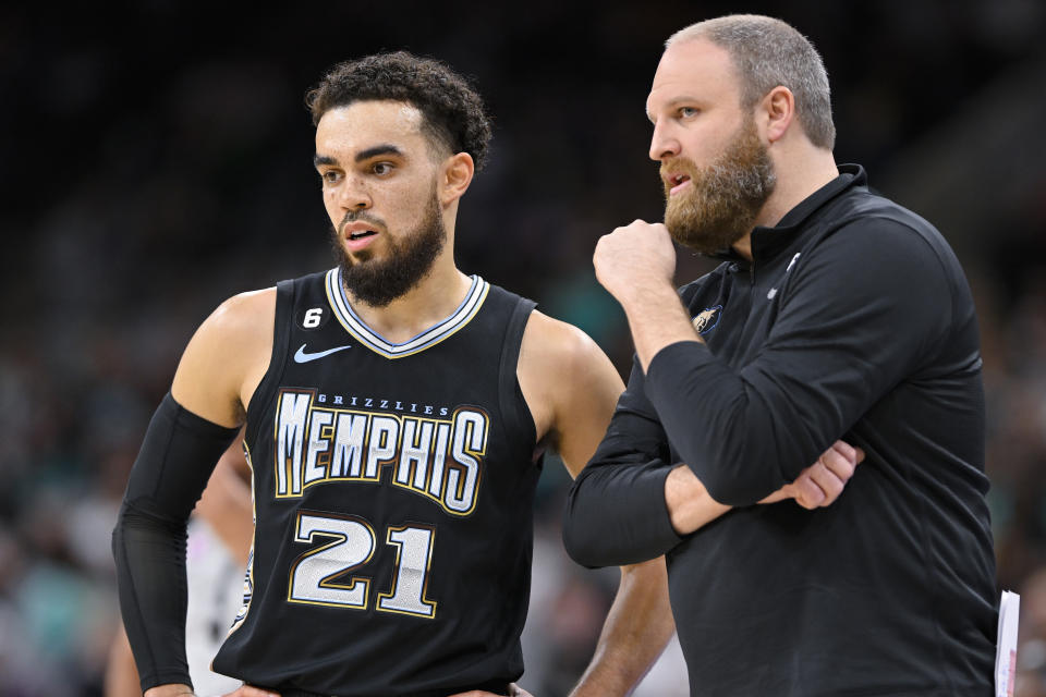 Memphis Grizzlies head coach Taylor Jenkins, right, speaks with guard Tyus Jones during the second half of an NBA basketball game against the San Antonio Spurs, Friday, March 17, 2023, in San Antonio. (AP Photo/Darren Abate)
